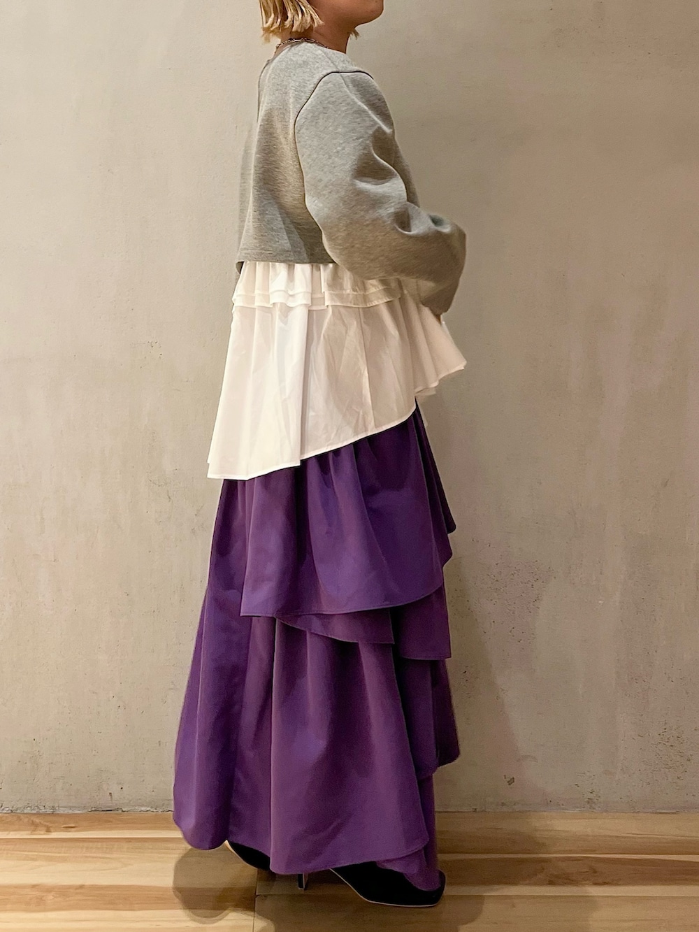 グレー系のTシャツ/カットソー、パープル系のスカート、ブラック系のブーツを着用したレディースの夏コーディネートの3枚目の写真