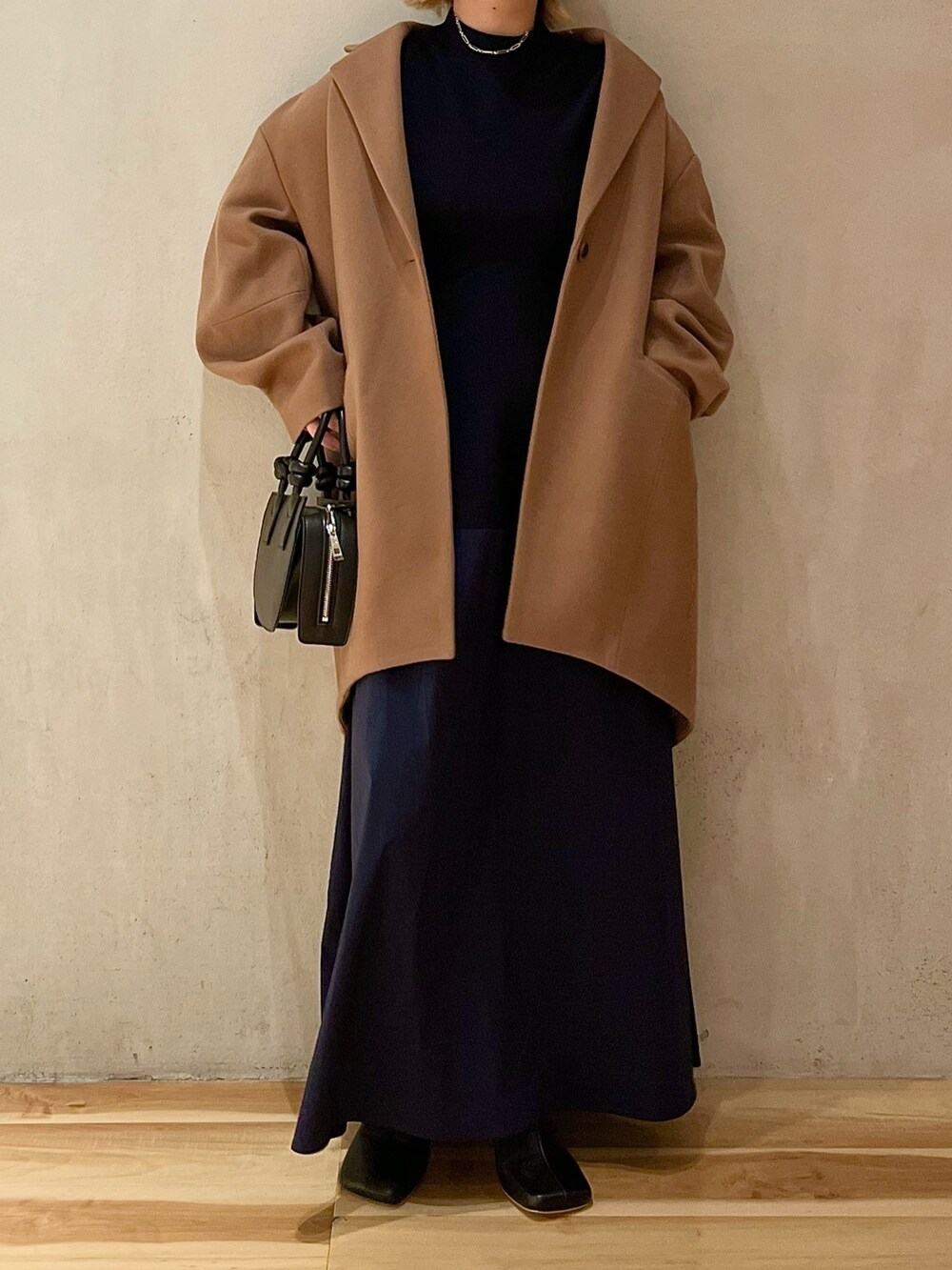 ベージュ系のチェスターコート、ブルー系のワンピース、ブラック系のブーツを着用したレディースの夏コーディネートの5枚目の写真