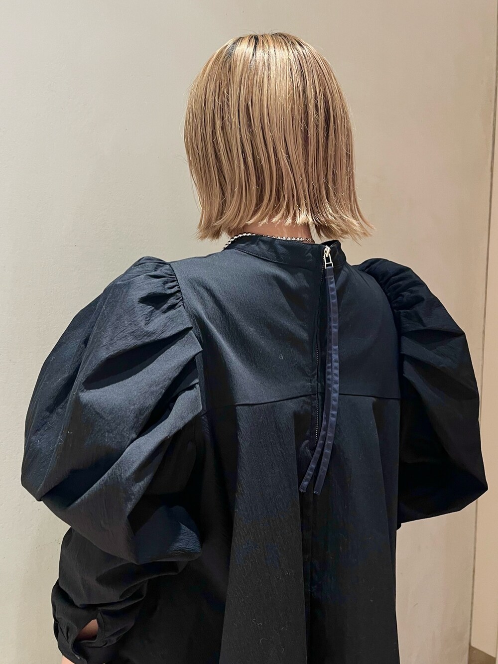 ブラック系のハンドバッグ、ブラック系のその他パンツ、ブラック系のシャツ/ブラウスを着用したレディースの冬コーディネートの7枚目の写真