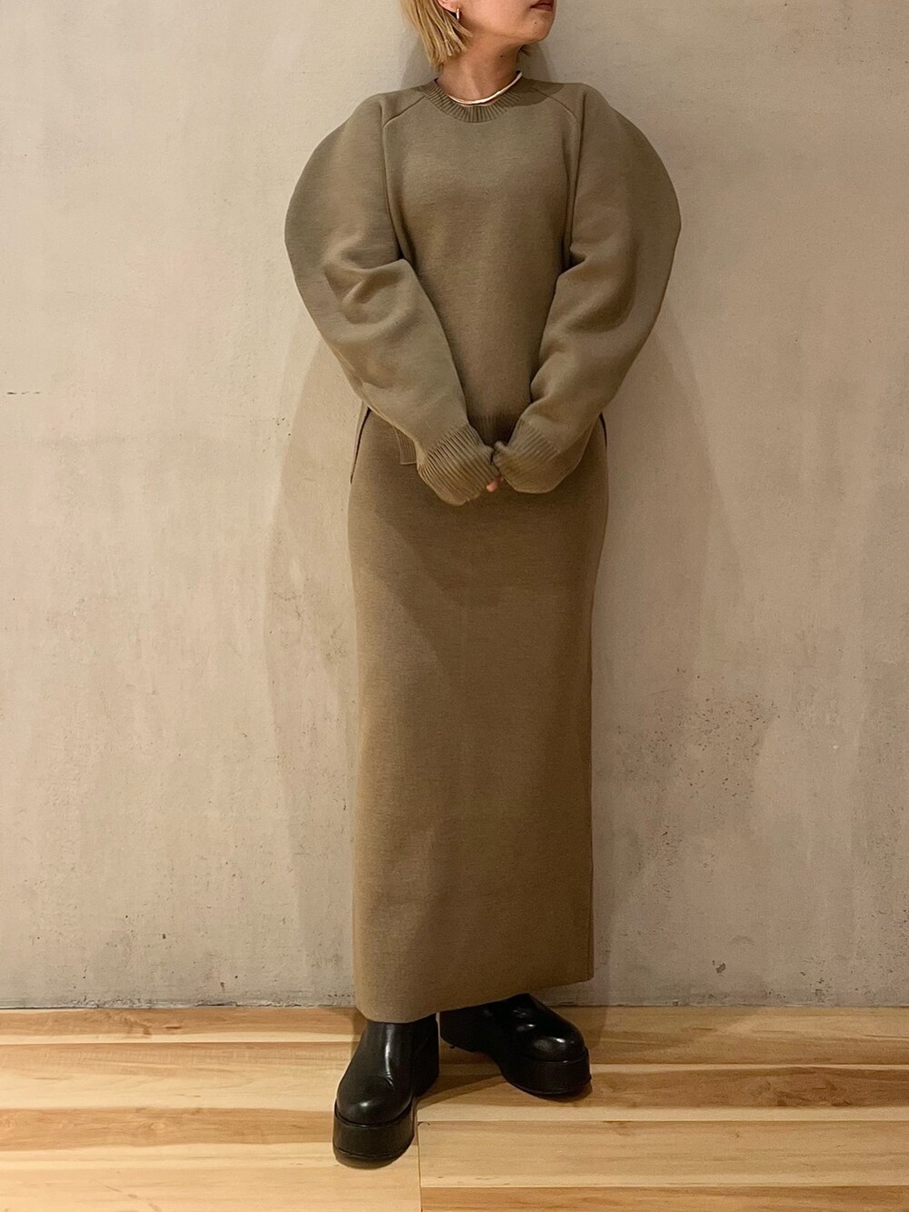 ベージュ系のダウンジャケット/コート、ベージュ系のスカート、ベージュ系のニット/セーターを着用したレディースの冬コーディネートの8枚目の写真