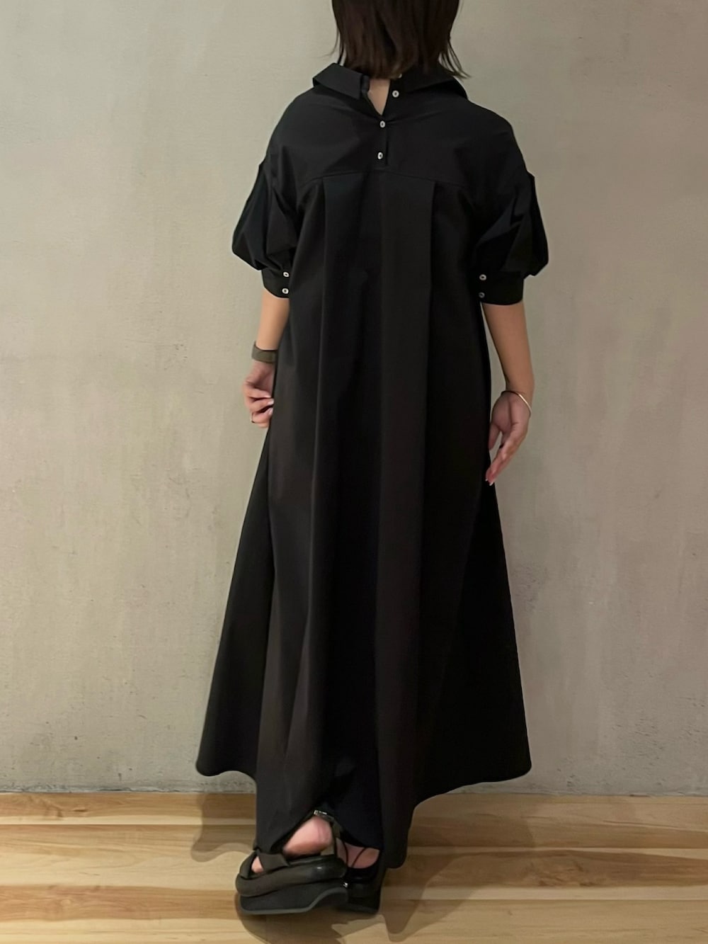 ブラック系のワンピースを着用したレディースの夏コーディネートの4枚目の写真