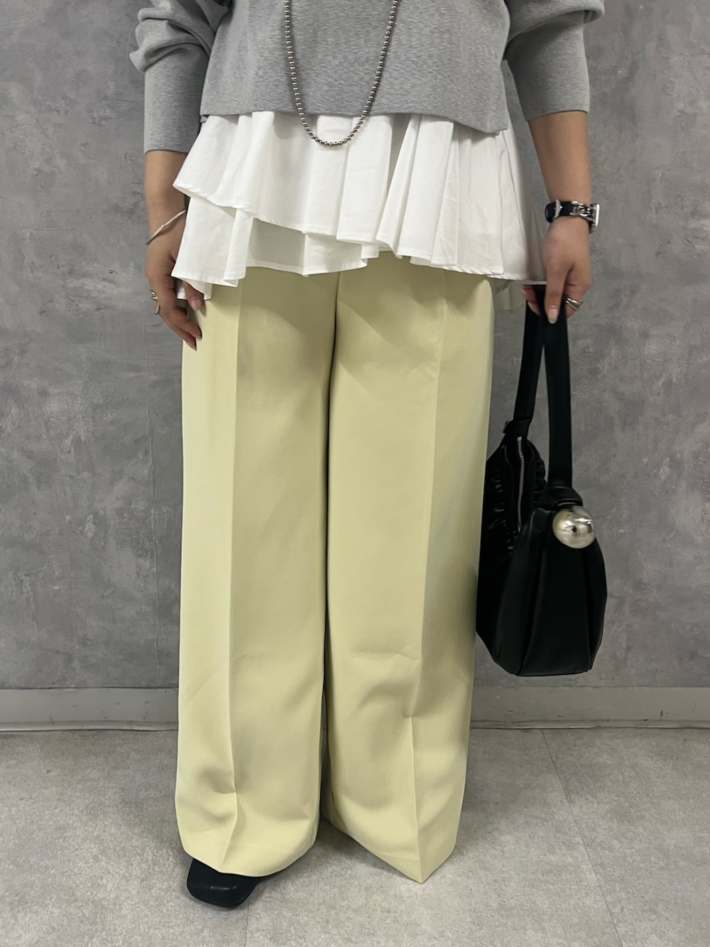 グレー系のノーカラージャケット、グレー系のニット/セーター、イエロー系のその他パンツを着用したレディースの秋コーディネートの10枚目の写真