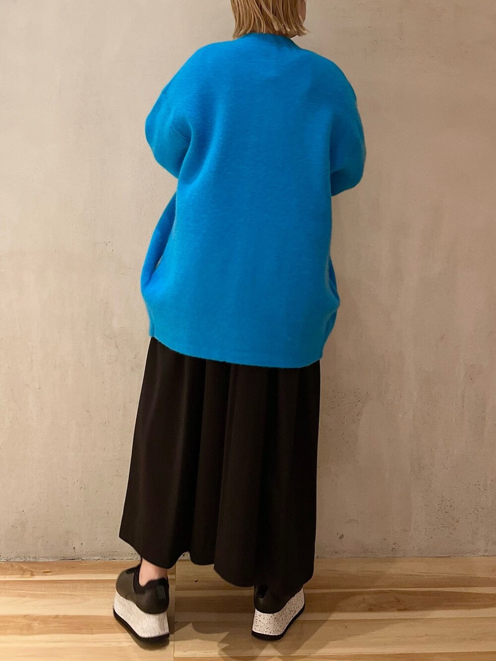 ブルー系のノーカラージャケット、ブラック系のワンピース、ブラック系のスニーカーを着用したレディースの夏コーディネートの4枚目の写真