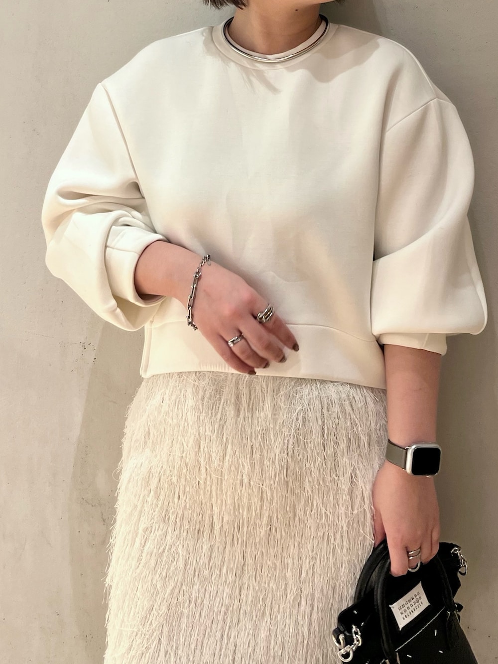 ホワイト系のTシャツ/カットソー、ホワイト系のスカート、ホワイト系のブーツを着用したレディースの春コーディネートの4枚目の写真