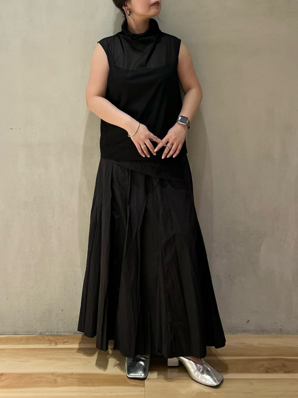 ブラック系のシャツ/ブラウス、ブラック系のスカート、シルバー系のパンプスを着用したレディースの夏コーディネートの4枚目の写真