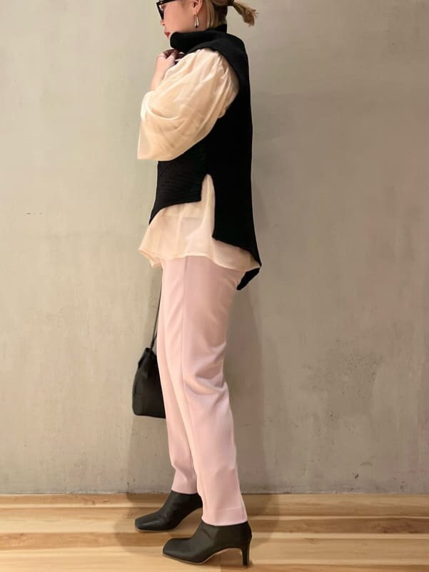 ブラック系のブーツ、ベージュ系のニット/セーター、ブラック系のワンピースを着用したレディースの秋コーディネートの4枚目の写真