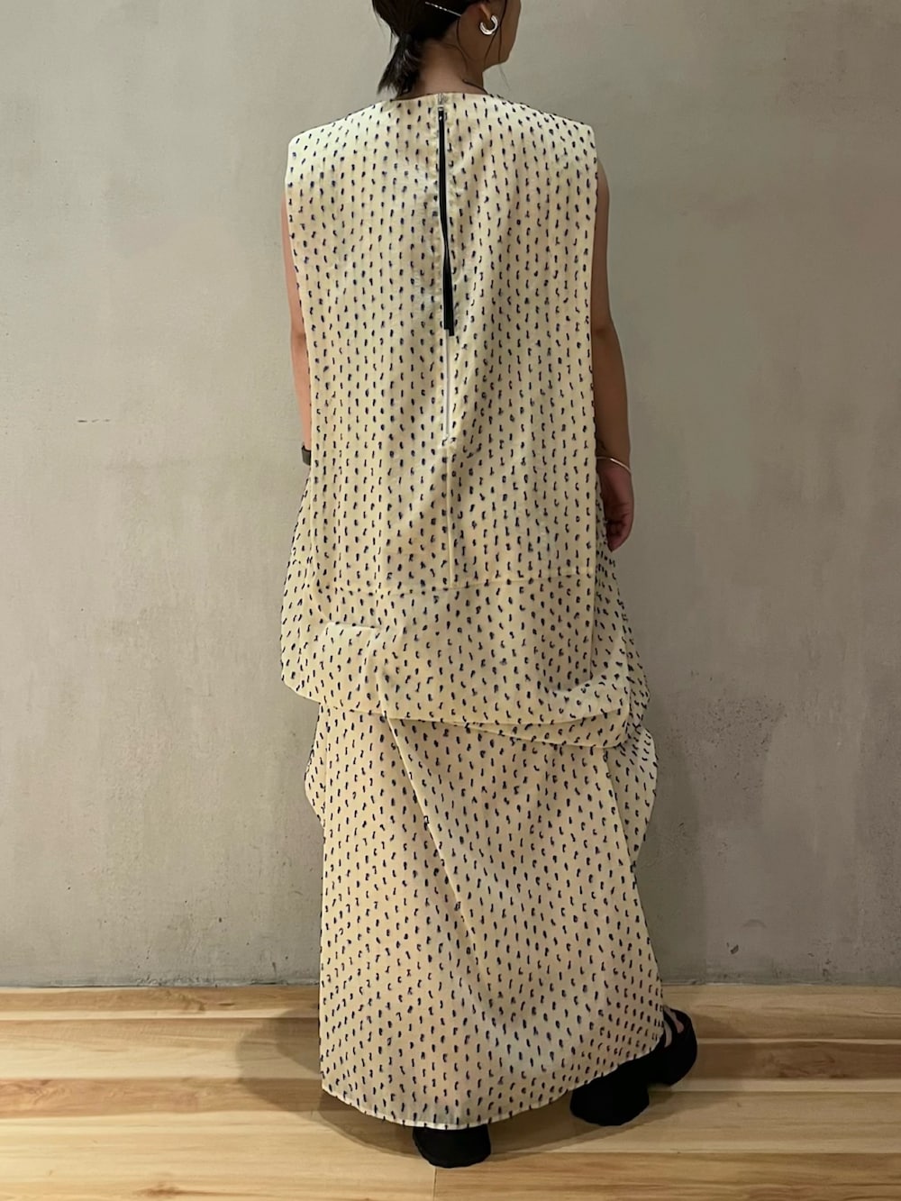 ホワイト系のワンピース、ブラック系のサンダルを着用したレディースの夏コーディネートの3枚目の写真