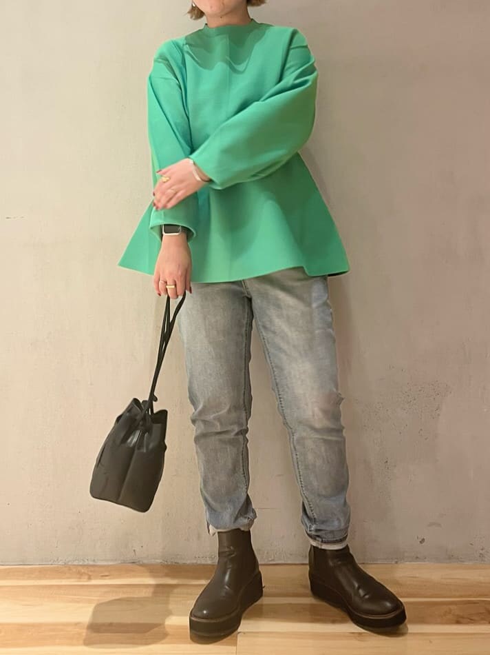 ブルー系のデニムパンツ、ブルー系のデニムパンツ、グリーン系のニット/セーターを着用したレディースの秋コーディネートの4枚目の写真