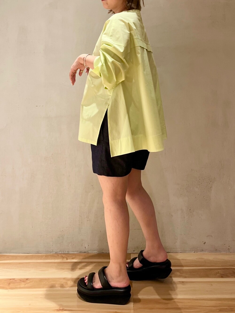 ブルー系のその他パンツ、ブラック系のサンダル、イエロー系のシャツ/ブラウスを着用したレディースの冬コーディネートの2枚目の写真