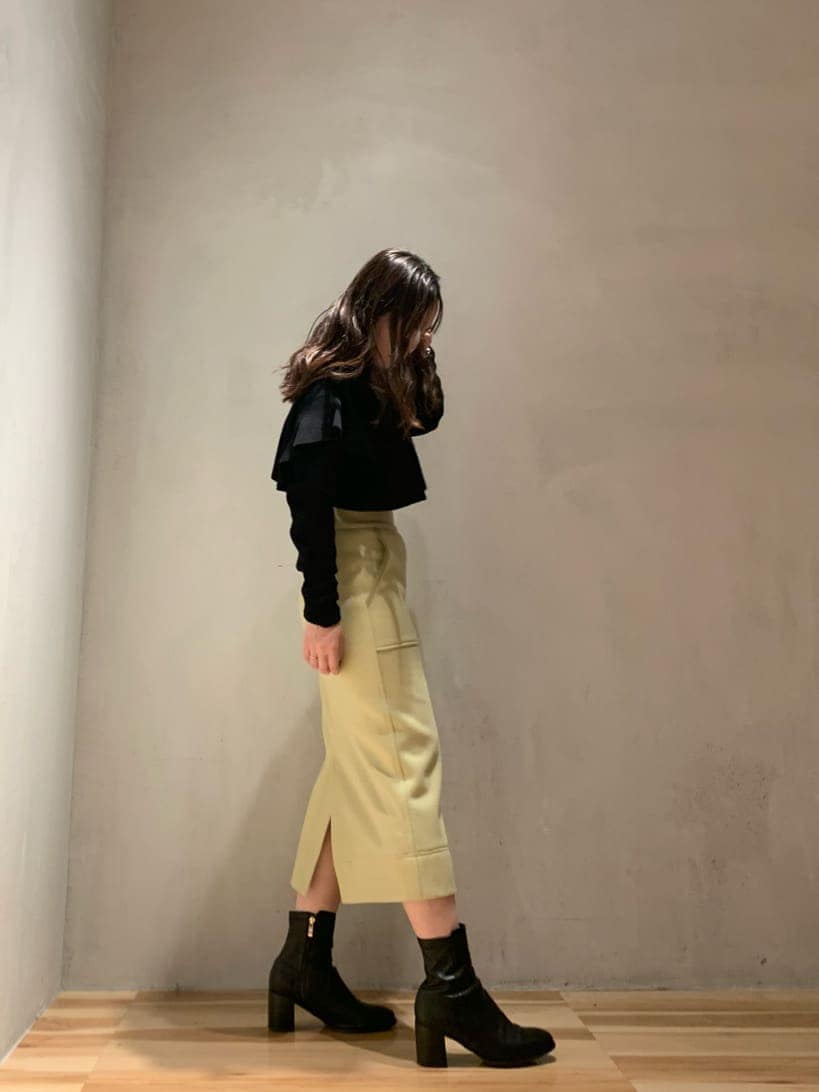 ブラック系のその他アウター、イエロー系のスカート、ブラック系のニット/セーターを着用したレディースの秋コーディネートの4枚目の写真