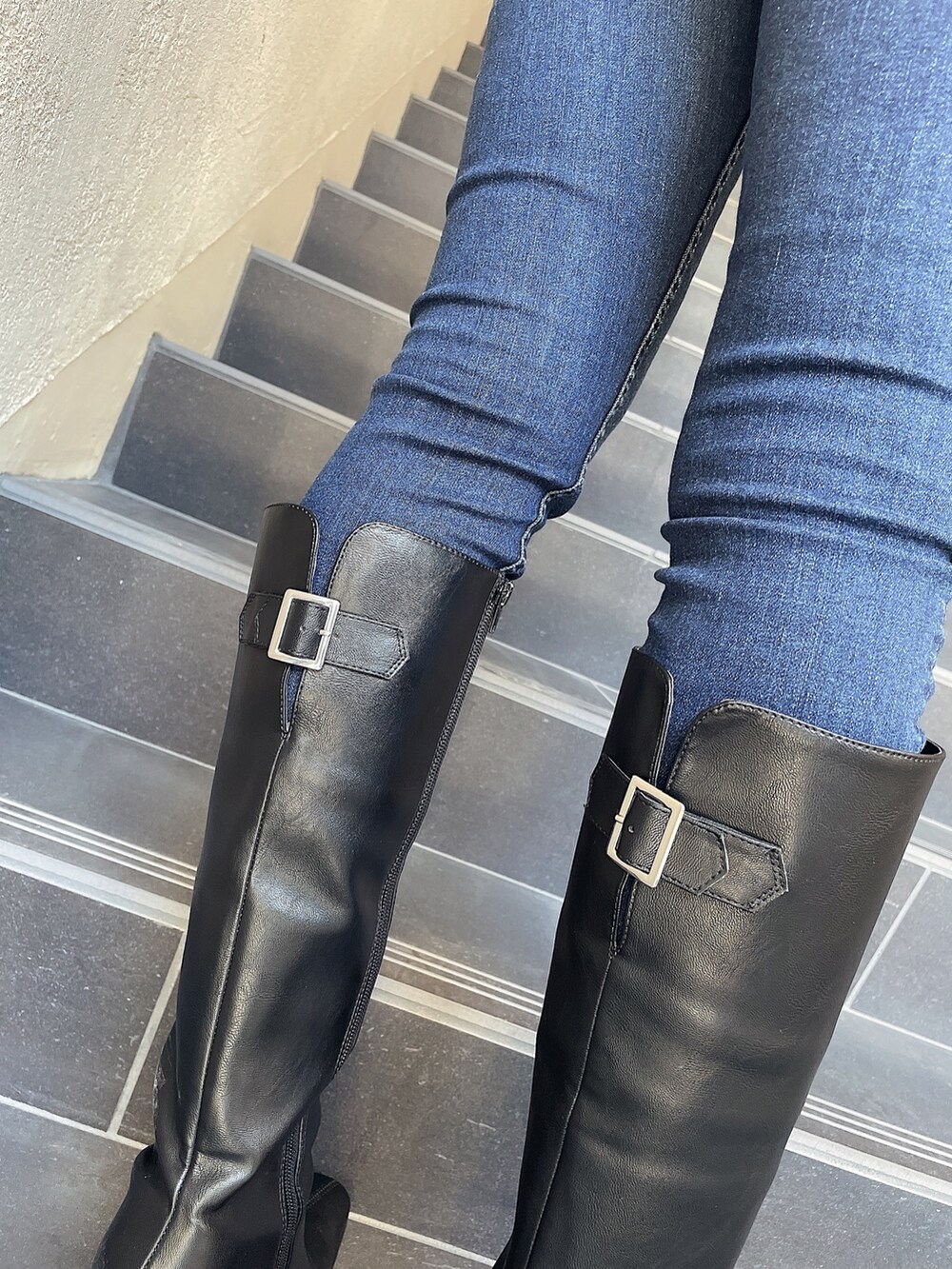 ベージュ系のニット/セーター、ブルー系のデニムパンツ、ブラック系のブーツを着用したレディースの秋コーディネートの6枚目の写真