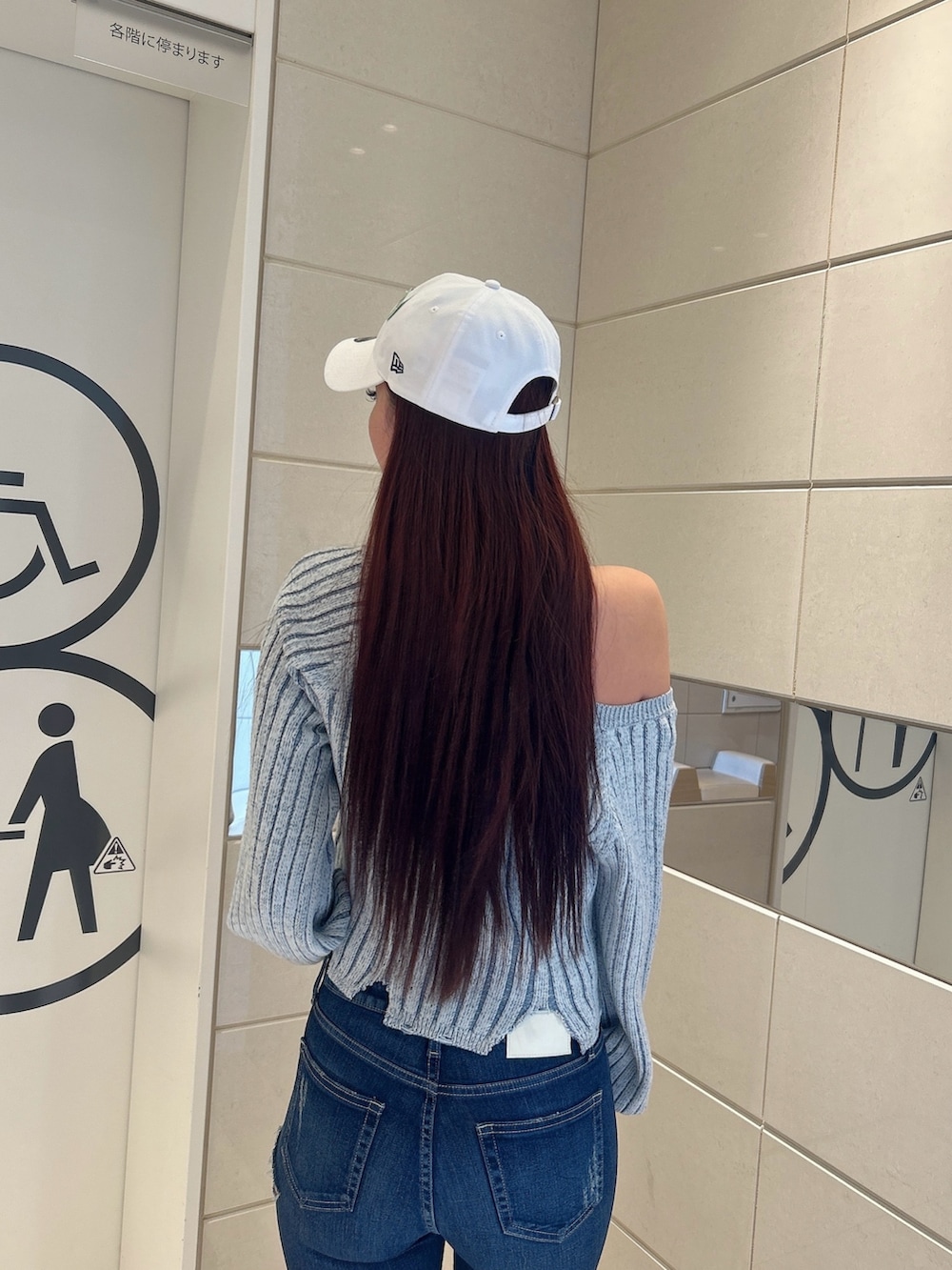 ブルー系のデニムパンツ、ブラック系のニット/セーター、ブラック系のパンプスを着用したレディースの冬コーディネートの7枚目の写真