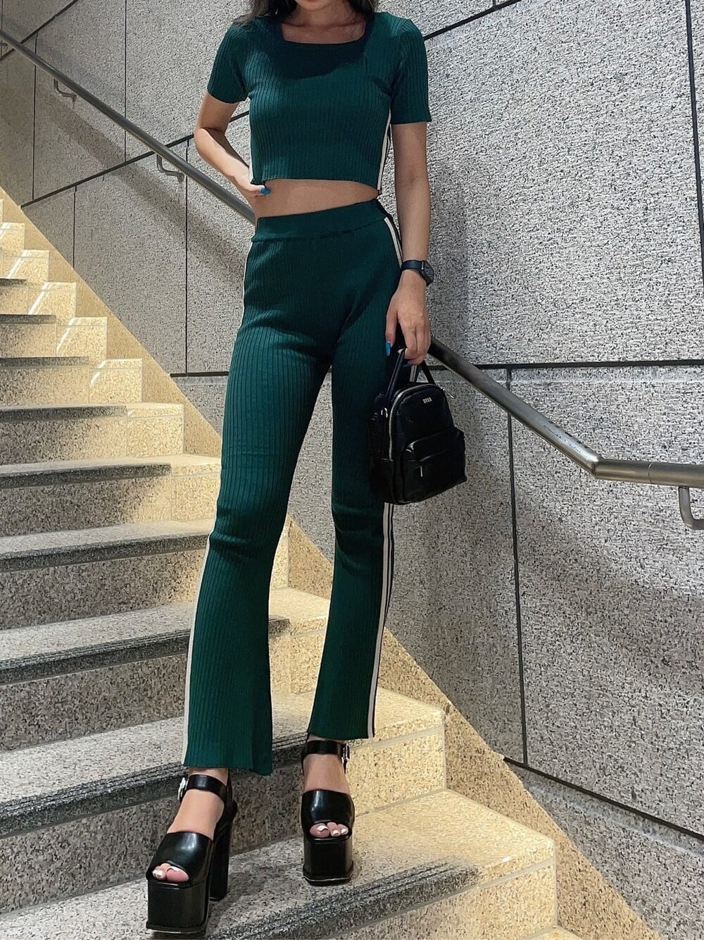 グリーン系のその他パンツ、グリーン系のニット/セーター、ブラック系のバックパック/リュックを着用したレディースの夏コーディネートの4枚目の写真