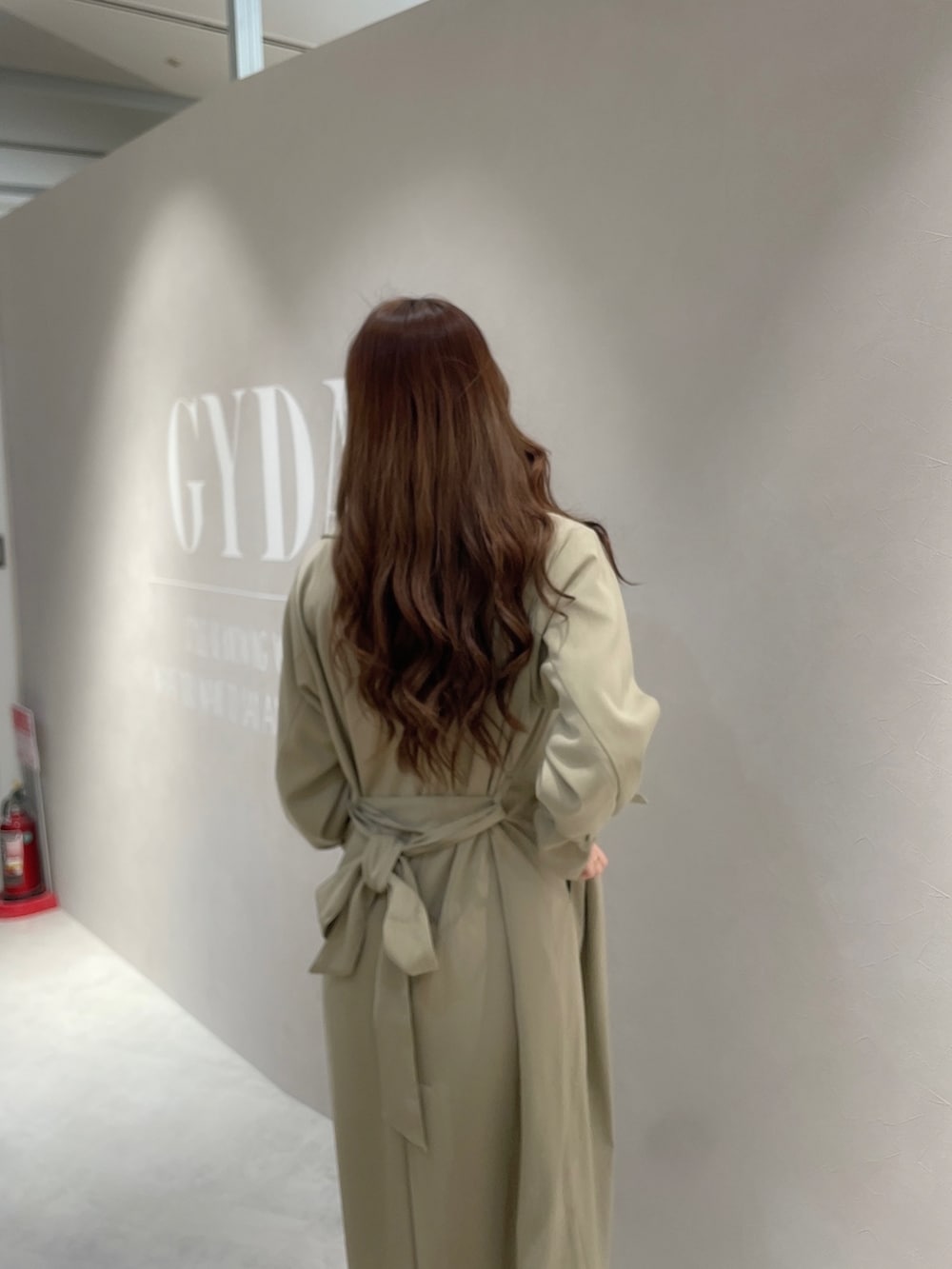 ブルー系のデニムパンツ、ホワイト系のTシャツ/カットソー、ベージュ系のトレンチコートを着用したレディースの春コーディネートの5枚目の写真