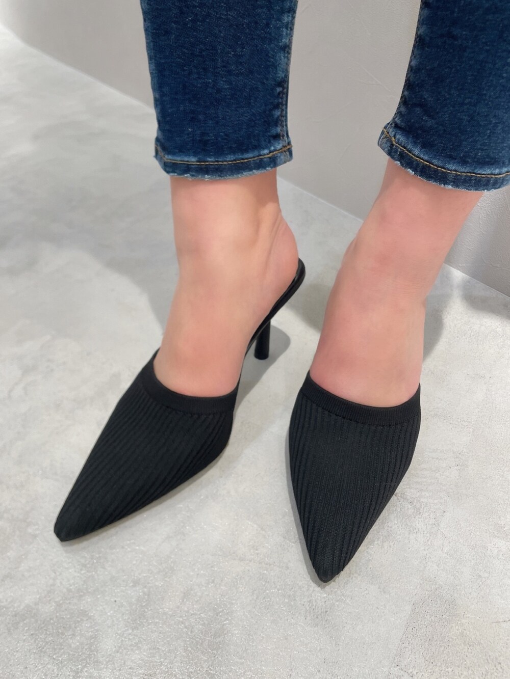 グリーン系のTシャツ/カットソー、ブルー系のデニムパンツ、ブラック系のパンプスを着用したレディースの春コーディネートの7枚目の写真