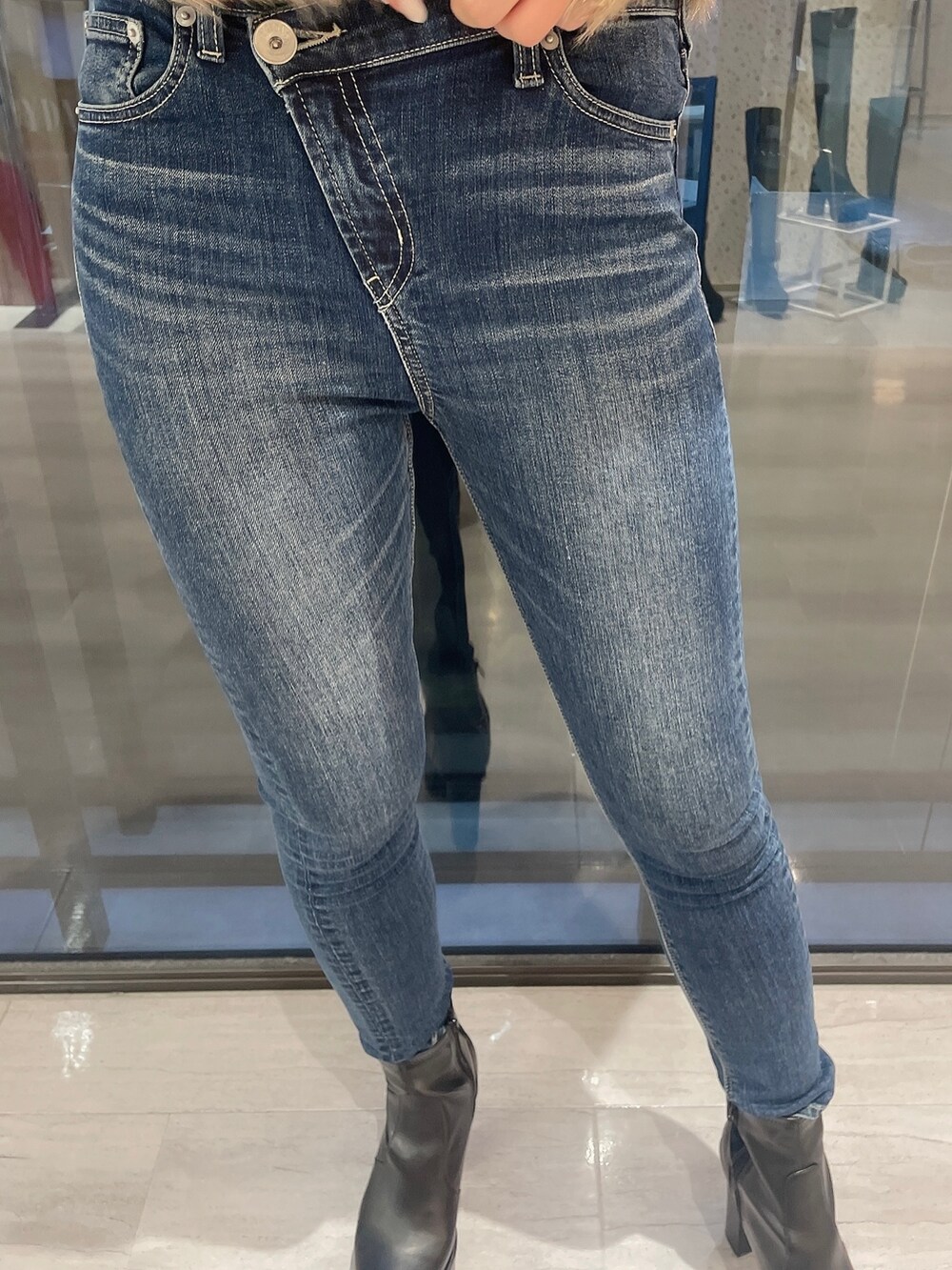 ベージュ系のニット/セーター、ブルー系のデニムパンツ、ブラック系のブーツを着用したレディースの冬コーディネートの7枚目の写真