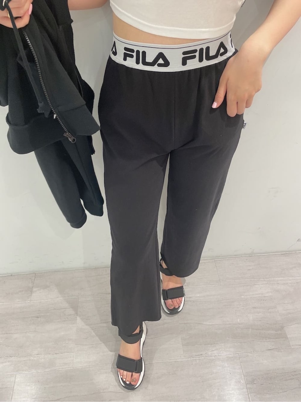 ブラック系のパーカー、グレー系のその他パンツ、ブラック系のキャミソールを着用したレディースの春コーディネートの6枚目の写真