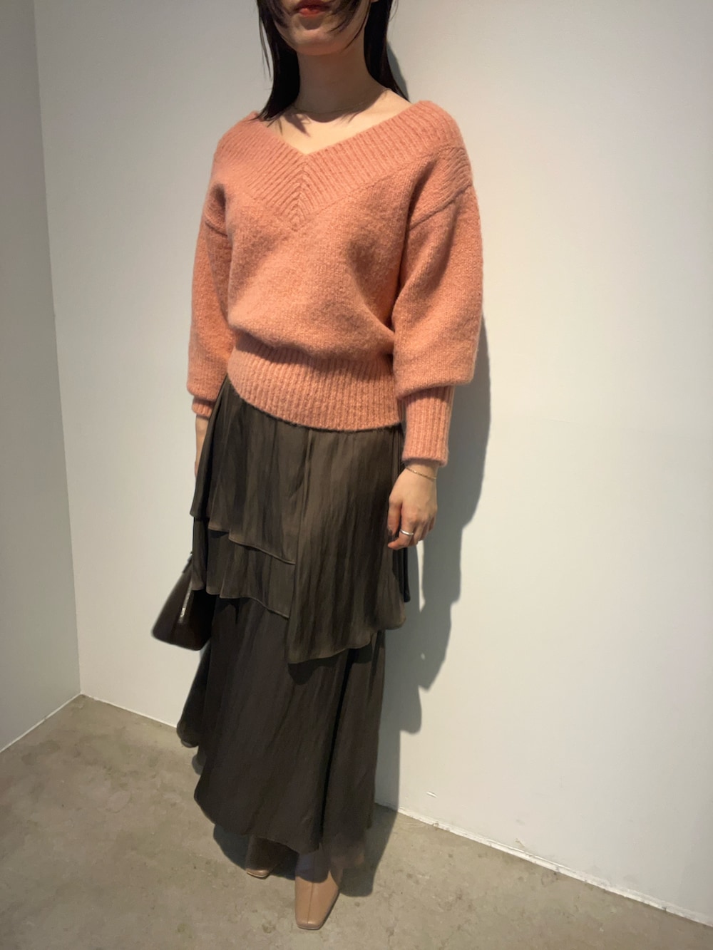 ピンク系のニット/セーター、ベージュ系のブーツ、ブラウン系のスカートを着用したレディースの秋コーディネートの6枚目の写真