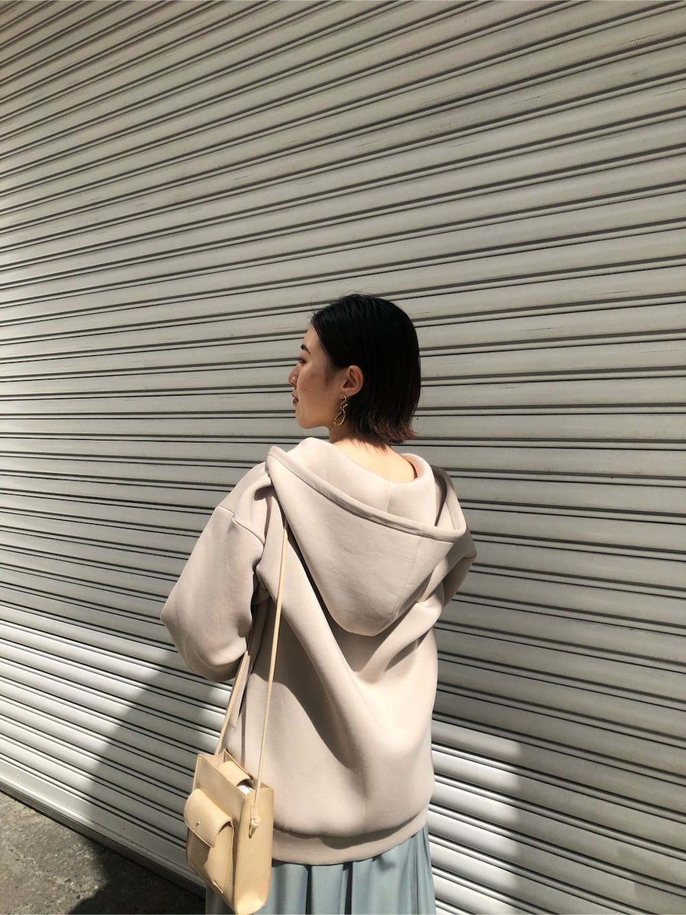 ホワイト系のスニーカー、ベージュ系のTシャツ/カットソー、グリーン系のワンピースを着用したレディースの春コーディネートの6枚目の写真