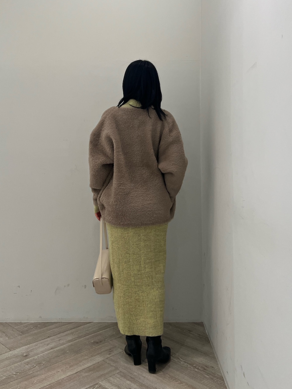 ブラウン系のカーディガン/ボレロ、グリーン系のワンピースを着用したレディースの冬コーディネートの3枚目の写真