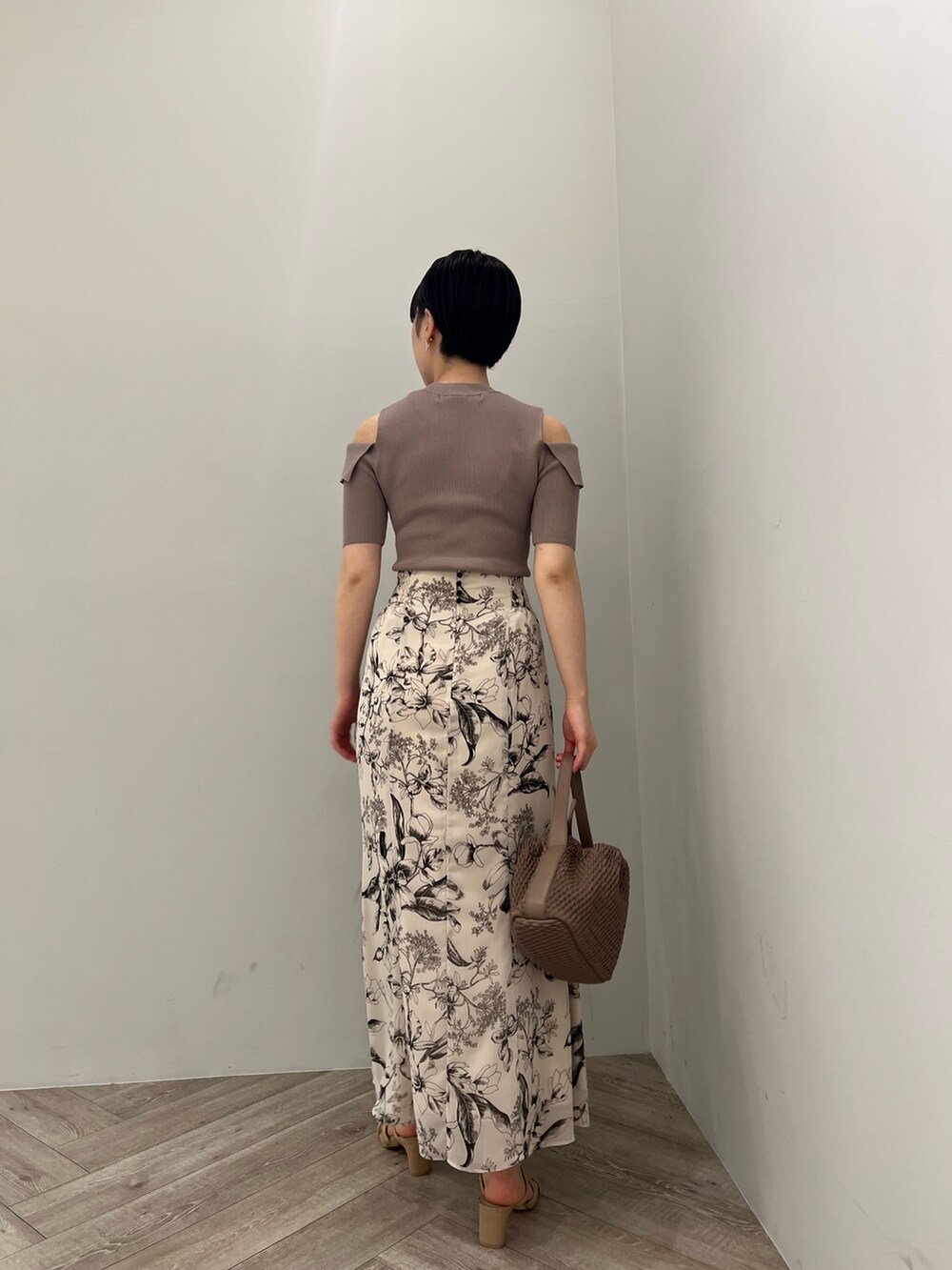 ブラウン系のサンダル、ホワイト系のスカート、ベージュ系のニット/セーターを着用したレディースの春コーディネートの6枚目の写真