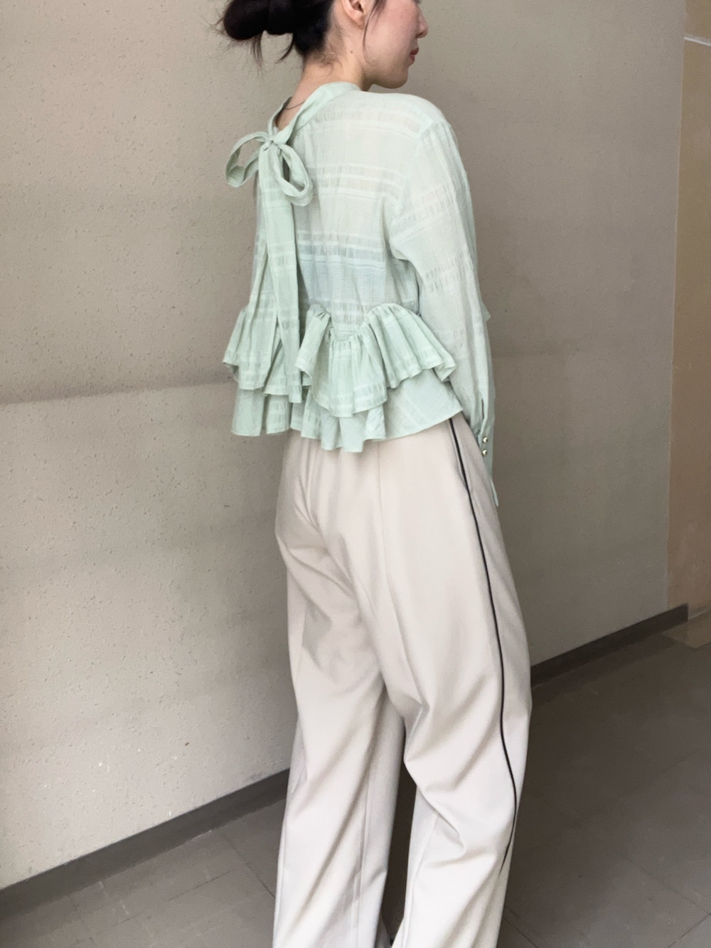 ベージュ系のその他パンツ、グリーン系のシャツ/ブラウス、ブラック系のパンプスを着用したレディースの春コーディネートの5枚目の写真