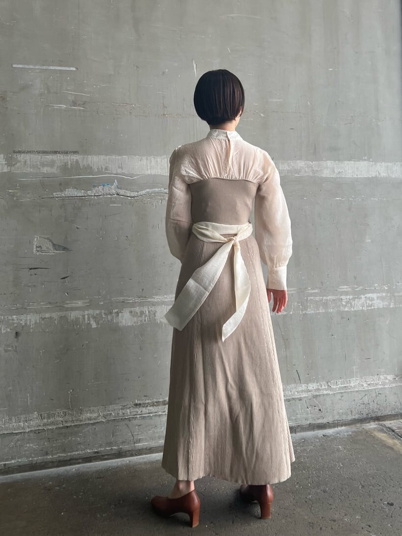 ホワイト系のトレンチコート、ベージュ系のワンピース、ベージュ系のハンドバッグを着用したレディースの春コーディネートの7枚目の写真