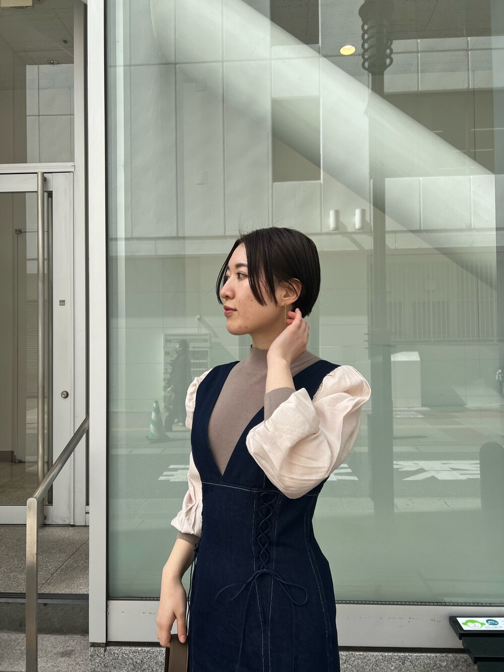 ベージュ系のカーディガン/ボレロ、レッド系のブーツ、ブラウン系のニット/セーターを着用したレディースの冬コーディネートの4枚目の写真