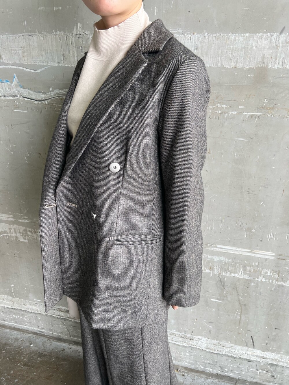 ブラウン系のスカート、ブラウン系のテーラードジャケット、ホワイト系のハンドバッグを着用したレディースの秋コーディネートの5枚目の写真