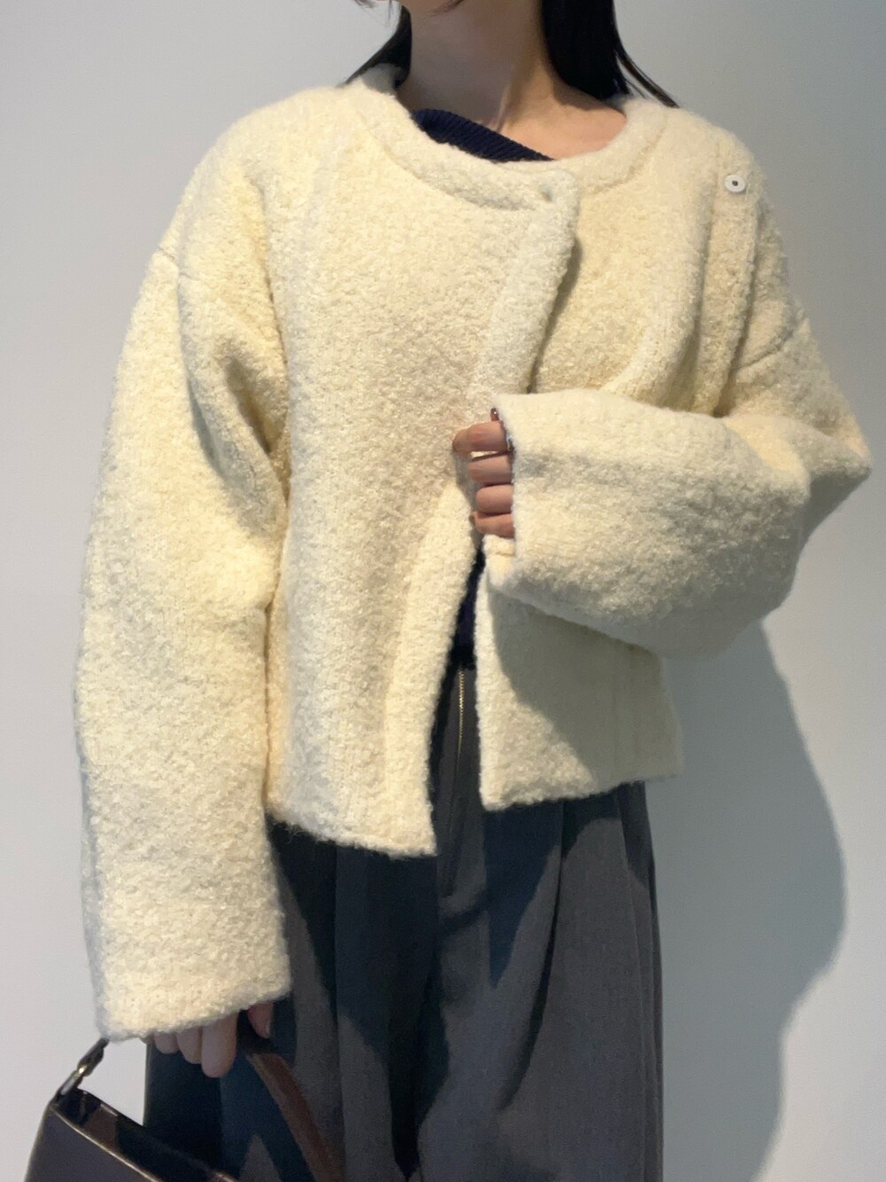 グレー系のその他パンツ、ブラウン系のハンドバッグ、ホワイト系のカーディガン/ボレロを着用したレディースの秋コーディネートの5枚目の写真