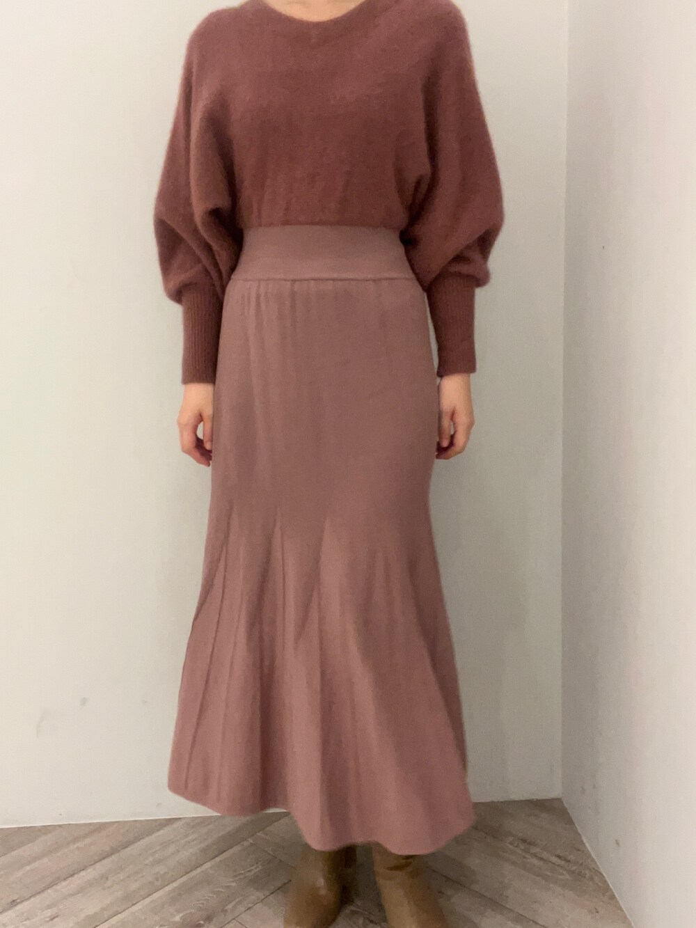 ピンク系のカーディガン/ボレロ、ピンク系のワンピース、ベージュ系のブーツを着用したレディースの秋コーディネートの8枚目の写真