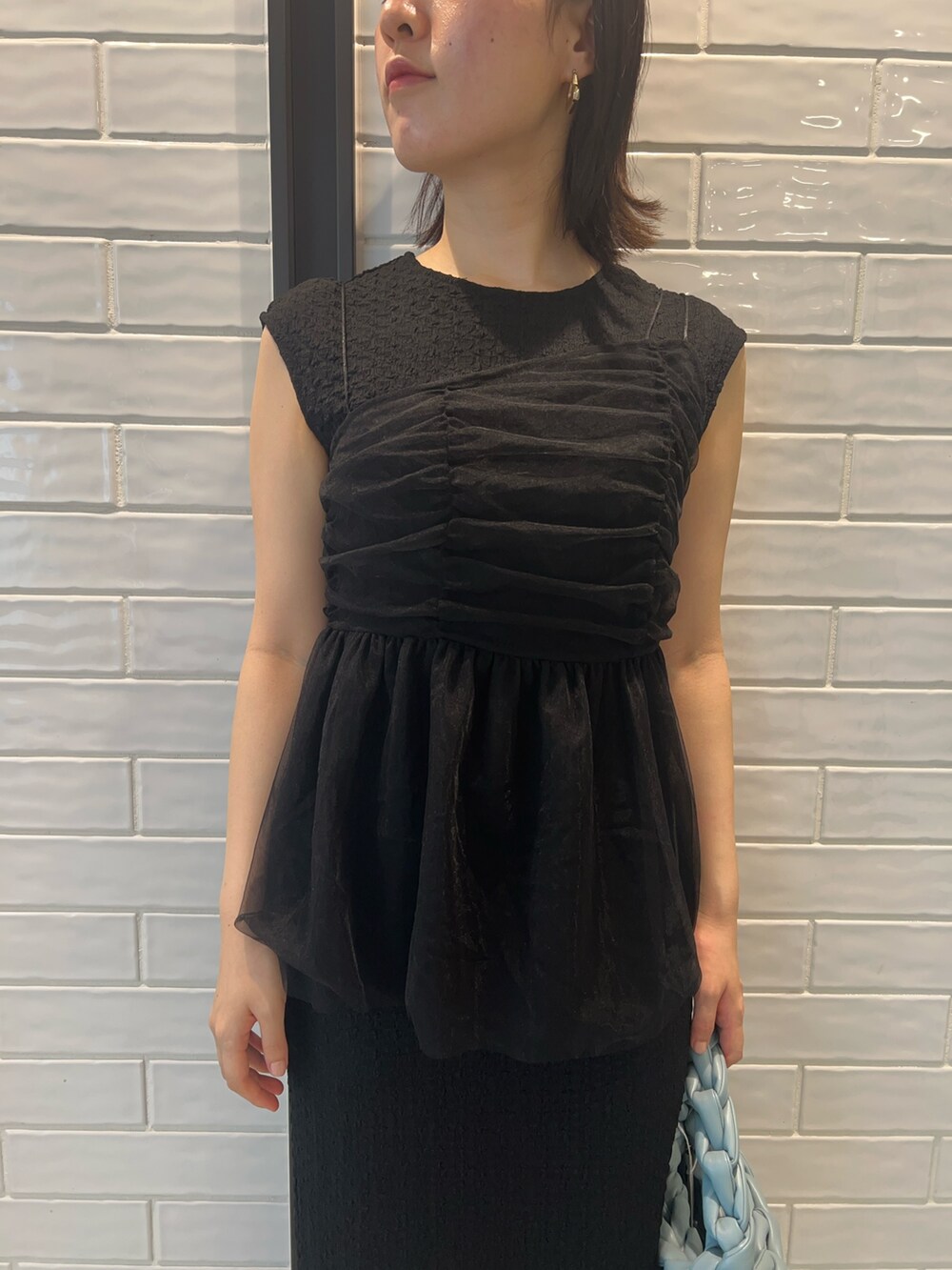 その他のサンダル、ブラック系のワンピース、ブルー系のハンドバッグを着用したレディースの夏コーディネートの5枚目の写真