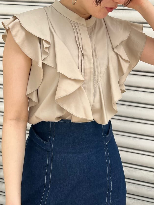 ベージュ系のハンドバッグ、ブルー系のスカート、その他のパンプスを着用したレディースの春コーディネートの4枚目の写真