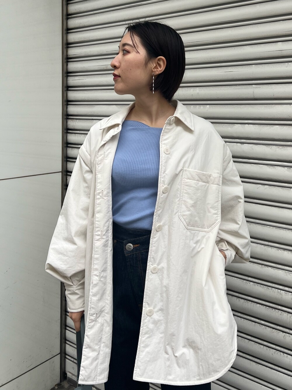 ブルー系のショルダーバッグ、ブルー系のニット/セーター、ベージュ系のブーツを着用したレディースの冬コーディネートの4枚目の写真