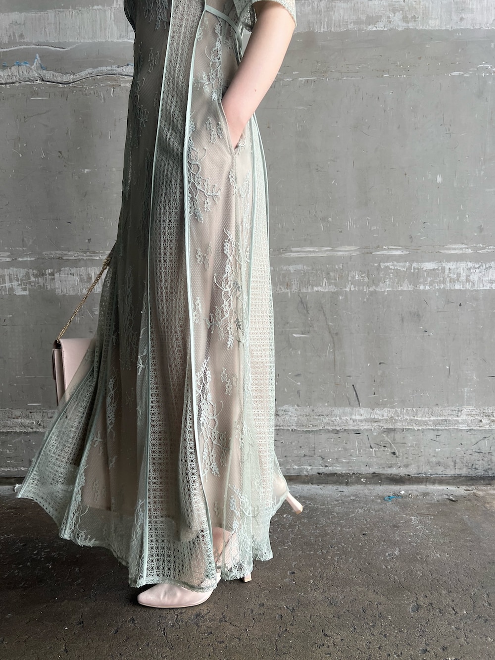 グリーン系のドレス、ベージュ系のパンプス、ベージュ系のクラッチバッグを着用したレディースの春コーディネートの8枚目の写真