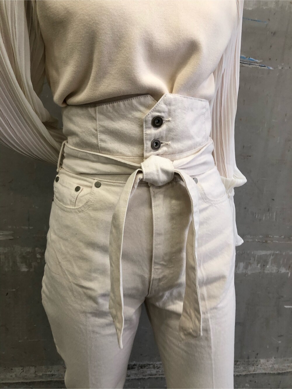 ブラウン系のパンプス、パープル系のハンドバッグ、ホワイト系のニット/セーターを着用したレディースの冬コーディネートの4枚目の写真