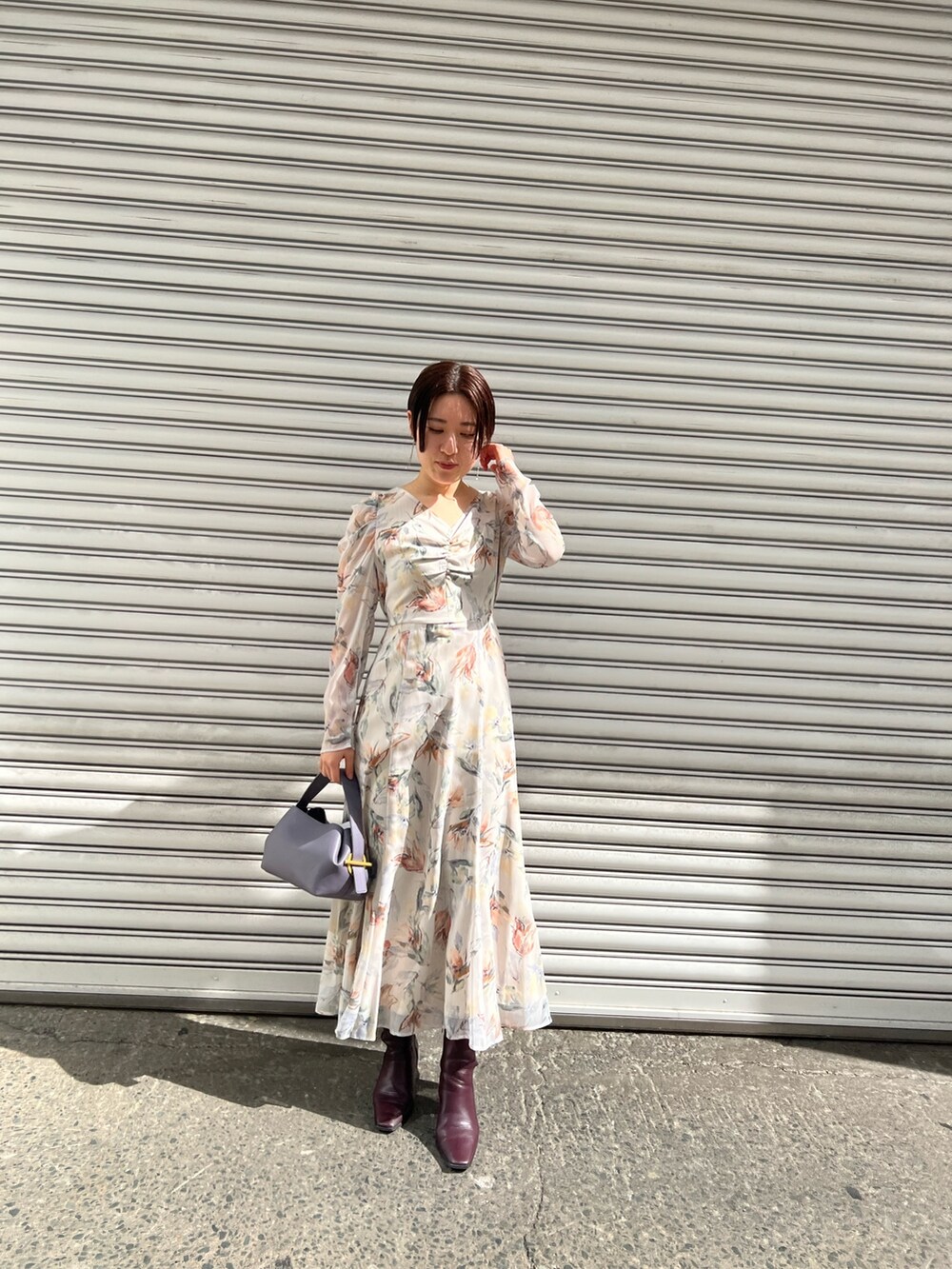 レッド系のブーツ、パープル系のハンドバッグ、ホワイト系のカーディガン/ボレロを着用したレディースの冬コーディネートの6枚目の写真