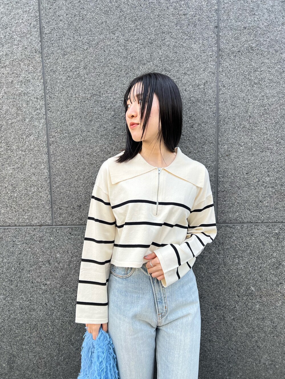 ブルー系のデニムパンツ、ホワイト系のニット/セーターを着用したレディースの冬コーディネートの4枚目の写真