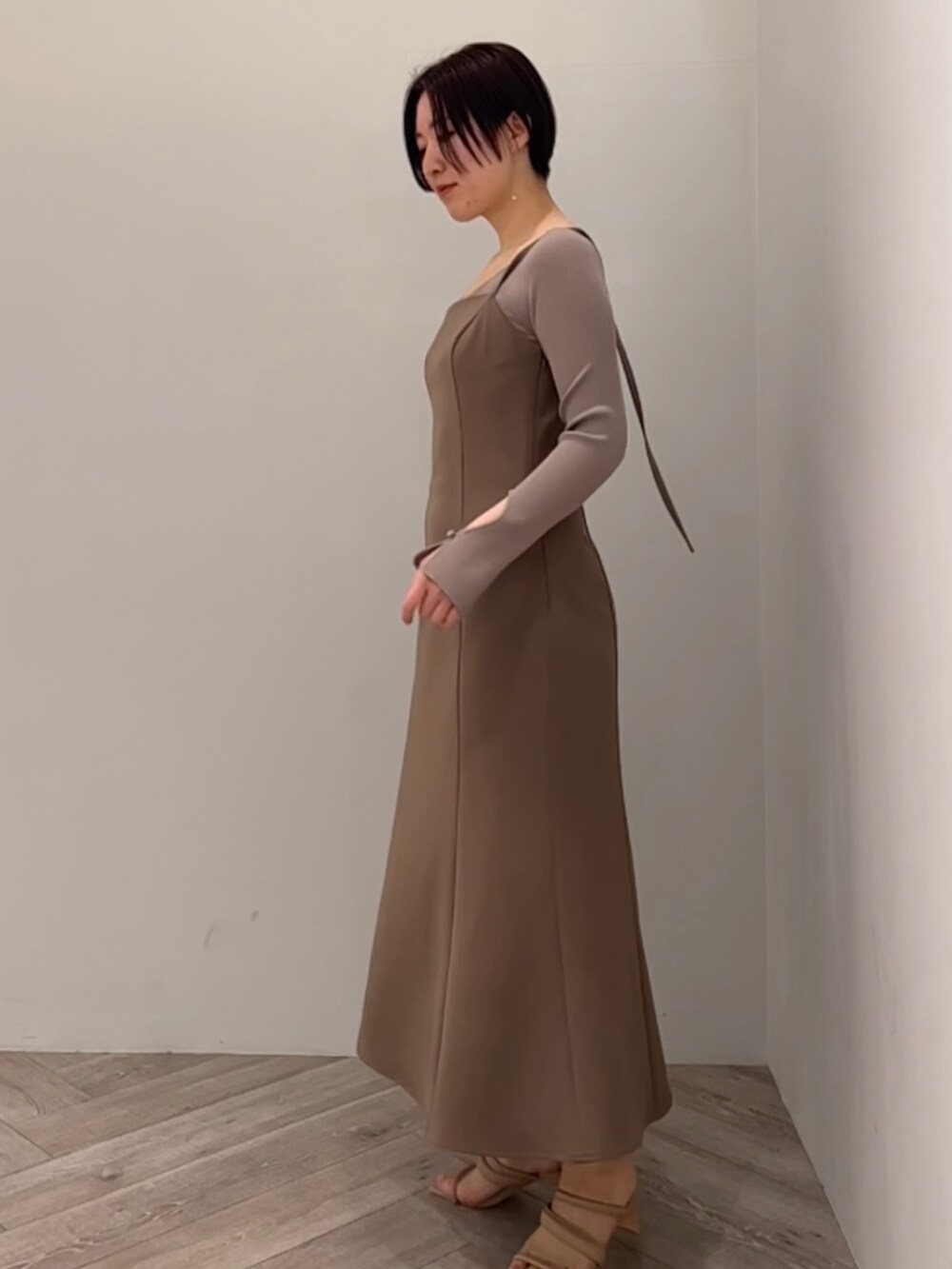 ブラウン系のニット/セーター、ベージュ系のサンダルを着用したレディースの冬コーディネートの3枚目の写真