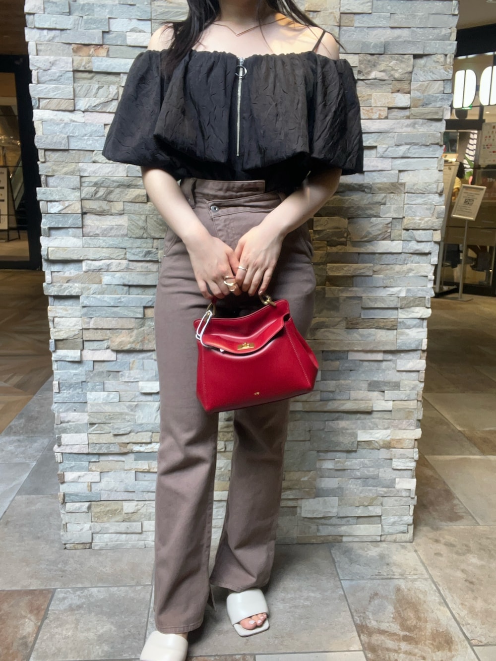 ベージュ系のデニムパンツ、ブラック系のシャツ/ブラウス、ホワイト系のサンダルを着用したレディースの夏コーディネートの4枚目の写真