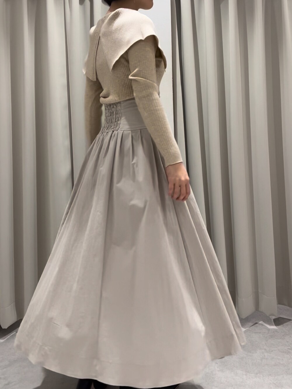 ベージュ系のスカート、ベージュ系のニット/セーターを着用したレディースの冬コーディネートの2枚目の写真