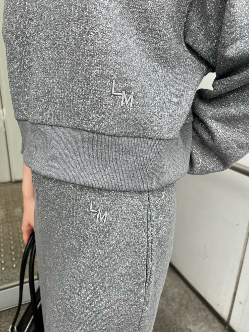 ブラック系のブーツ、グレー系のスカート、グレー系のスウェットを着用したレディースの秋コーディネートの9枚目の写真