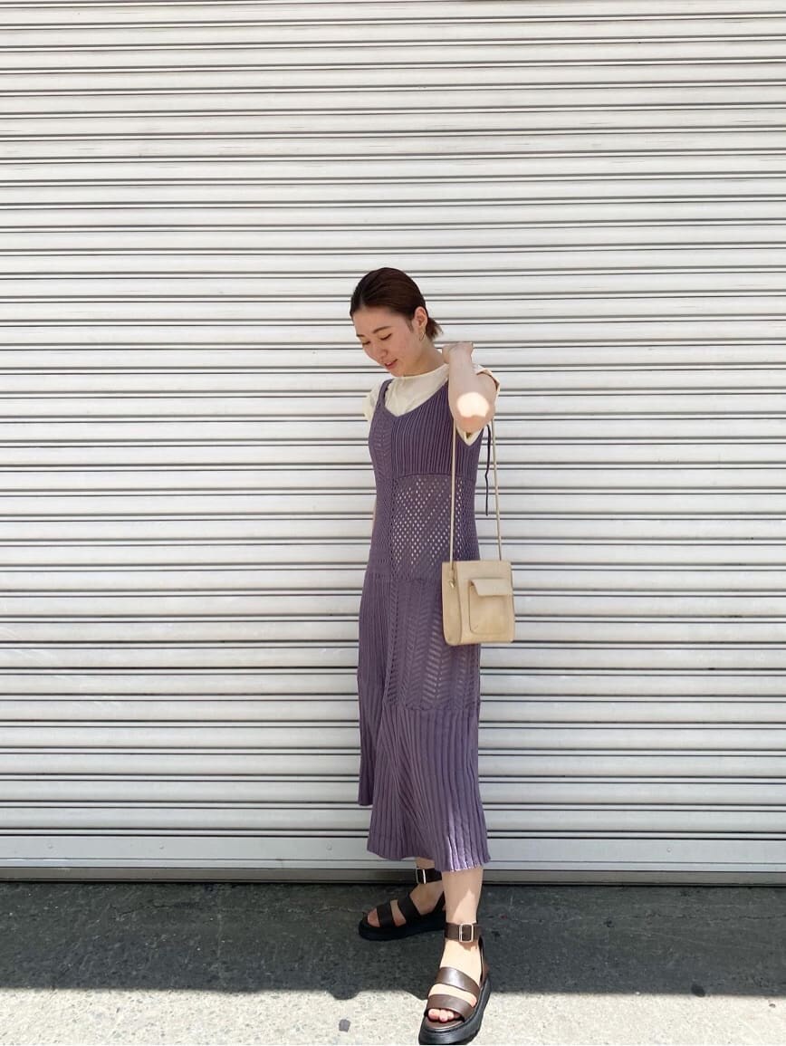 パープル系のワンピース、ベージュ系のハンドバッグ、ブラウン系のサンダルを着用したレディースの夏コーディネートの2枚目の写真