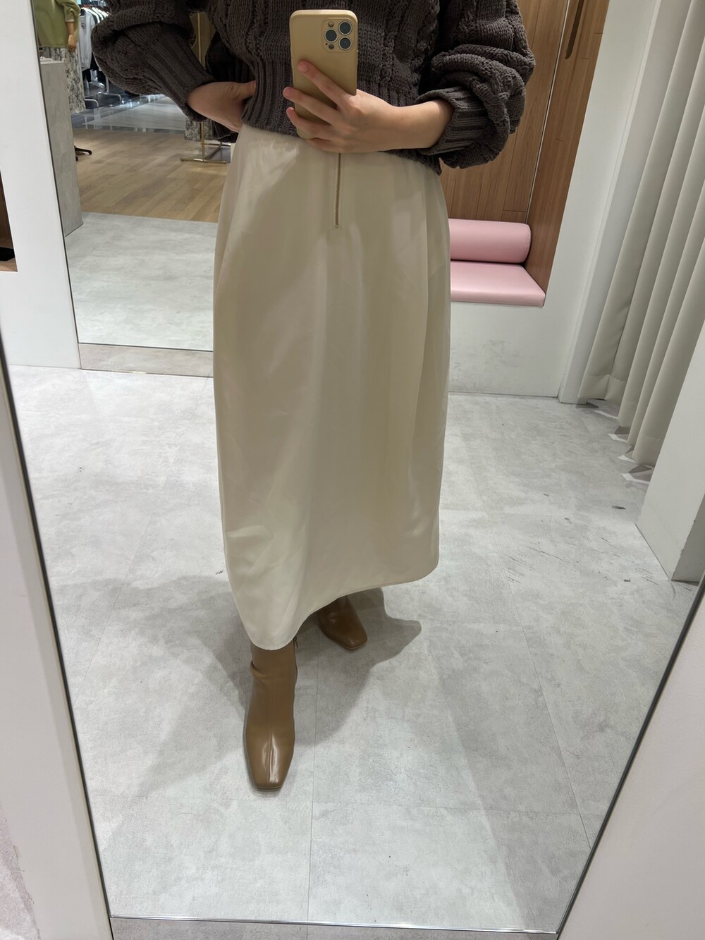 ホワイト系のスカート、グレー系のニット/セーター、ベージュ系のブーツを着用したレディースの秋コーディネートの4枚目の写真