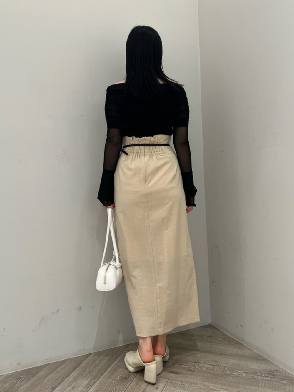 ホワイト系のサンダル、ベージュ系のスカート、ブラック系のTシャツ/カットソーを着用したレディースの春コーディネートの3枚目の写真