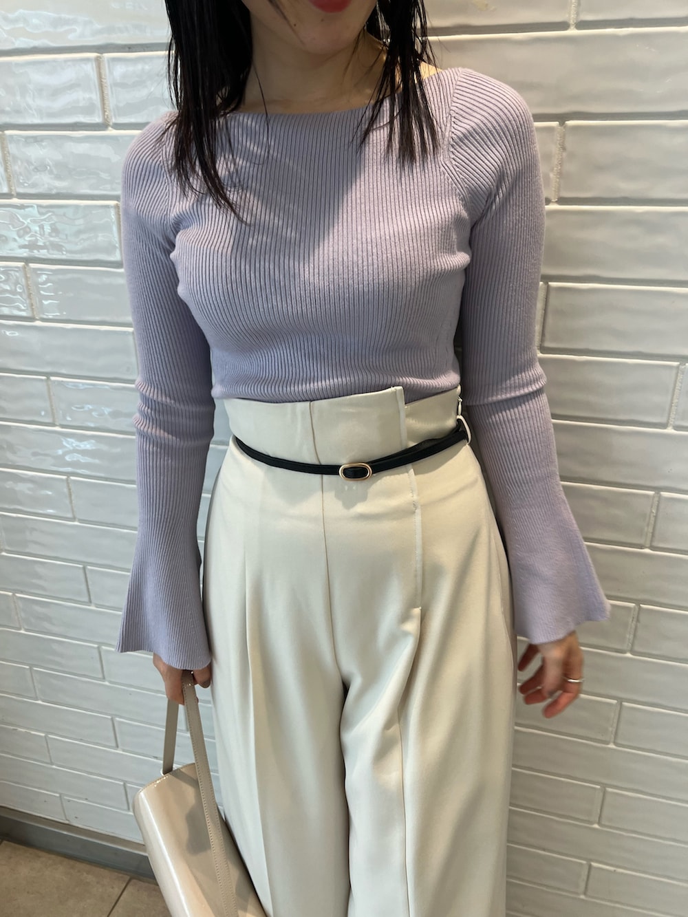 パープル系のニット/セーター、ホワイト系のその他パンツを着用したレディースの冬コーディネートの3枚目の写真