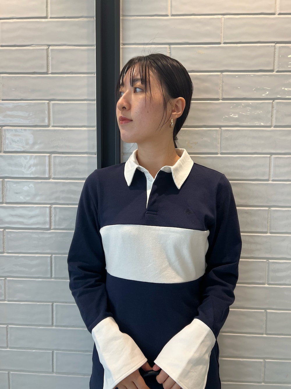 ブラック系のハンドバッグ、ブラック系のブーツ、ブルー系のワンピースを着用したレディースの秋コーディネートの4枚目の写真