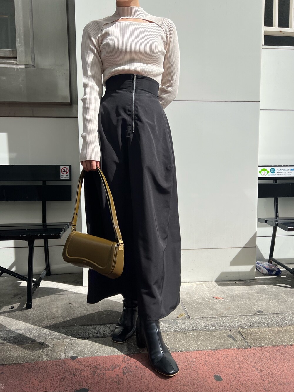 ホワイト系のニット/セーター、ブラック系のブーツ、ブラック系のスカートを着用したレディースの秋コーディネートの7枚目の写真