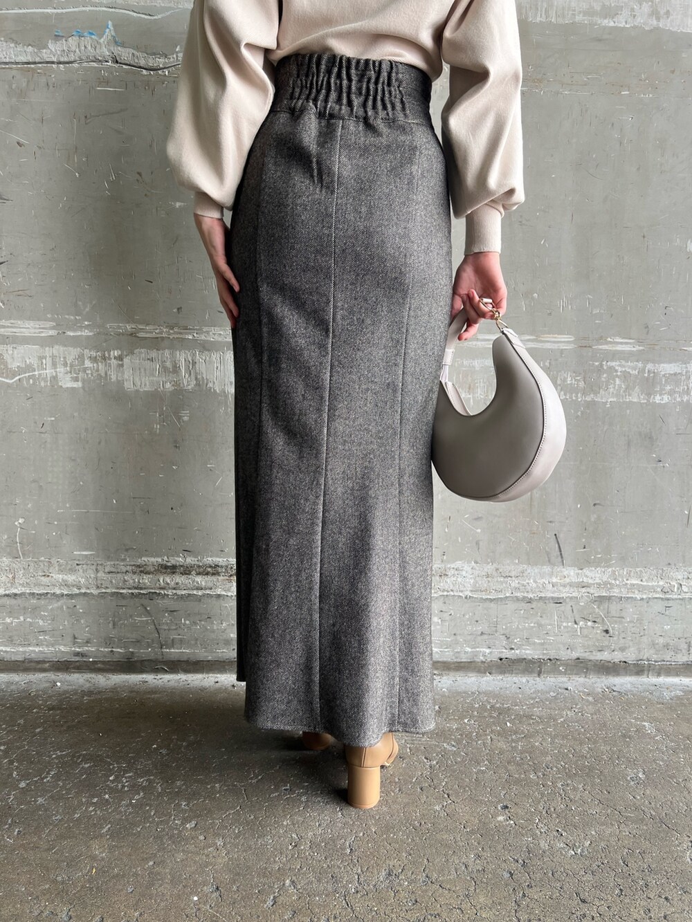 ブラウン系のスカート、ブラウン系のテーラードジャケット、ホワイト系のハンドバッグを着用したレディースの秋コーディネートの10枚目の写真