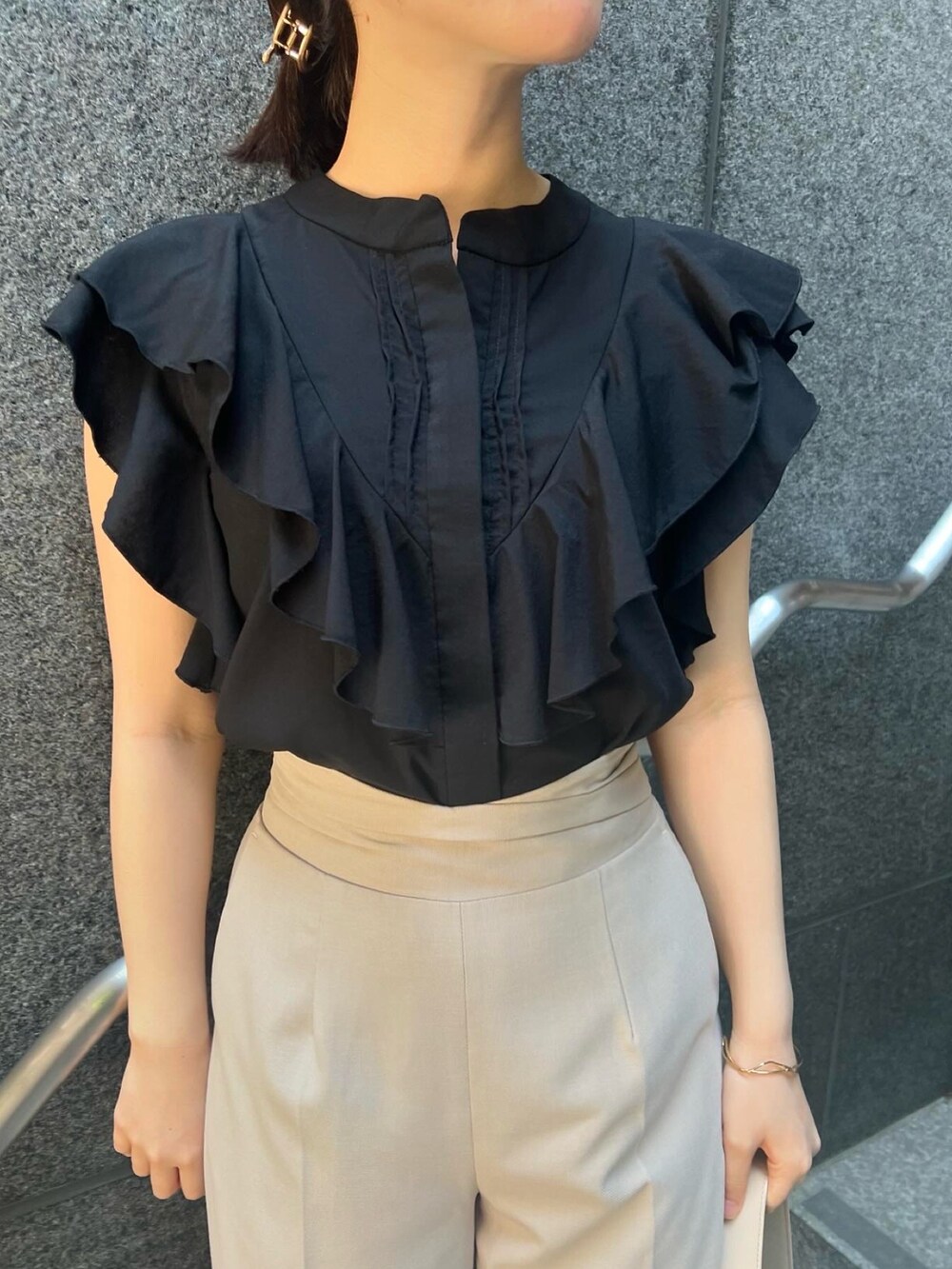 その他のサンダル、ベージュ系のハンドバッグ、ホワイト系のスラックスを着用したレディースの夏コーディネートの6枚目の写真